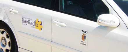 the BayRadio logo on the side of a taxi