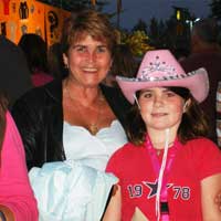 A little girl in a cowboy hat, and her mother