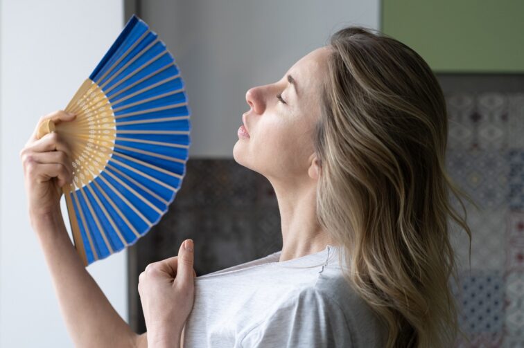 Overheated Woman In T Shirt Using Wave Fan Suffer From Heat Sweating, Cools Herself, Feels Sluggish