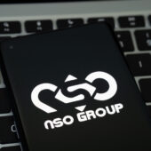 Nso,group,logo,seen,on,the,smartphone,placed,on,laptop